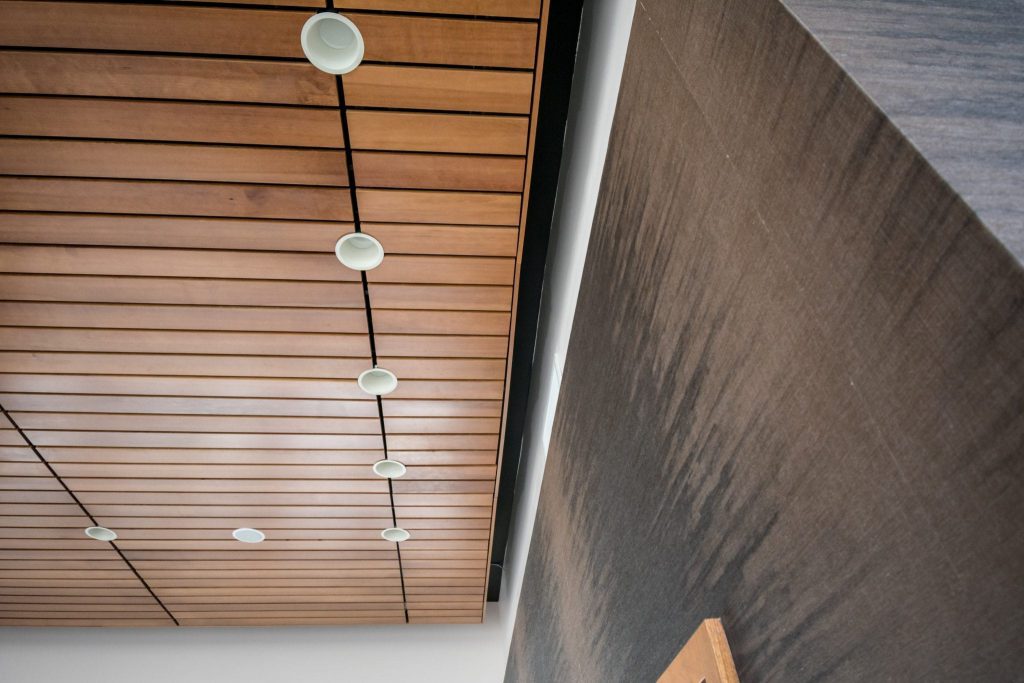 Lighting integration is crucial for linear wood ceilings. While acoustic subcontractors are skilled in installing to specification, nearly all lighting and MEP can integrate with a wood ceiling or a linear wood ceiling for that matter.