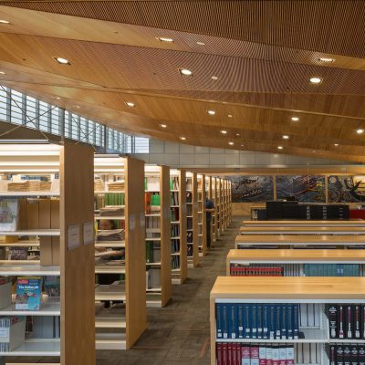 9Wood's 1100 Cross Piece Grill in Solid Western Hemlock with Stain at Alaska State Library, Archives and Museum, Juneau, Alaska. Hacker Architects. Photo: Lara Swimmer. In the library, the wood grille ceiling’s compound, pie- shaped sections flow from a height of 22’ down to 16’. Photo: Lara Swimmer.