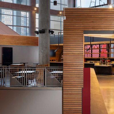 9Wood's 2300 Continuous Linear in White Oak Veneer with stain at State Farm Arena in Atlanta, Georgia. HOK. The “club” area showcases a mixed use of materials. The design approach was to create “a new, welcoming living room for Atlanta,” says Architect Emily Louchart of HOK. Photo: Creative Sources Photography.