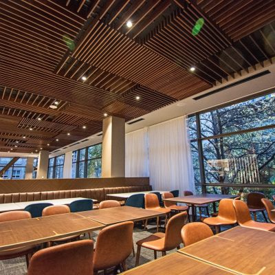 9Wood's 1100 Cross Piece Grille at the Hyatt Regency Seattle in Seattle, Washington. LMN Architects. The varying lengths and patterns of the wood grille panels form a parquet. The installation was difficult. Each panel had a unique location and orientation, and numerous sprinklers, speakers and light fixtures had to be integrated.