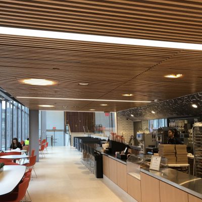 9Wood's 1100 Cross Piece Grille in FSC certified Solid European Beech with Clear Finish at The Smith Campus Center, Harvard University, Cambridge, Massachusetts. Hopkins Architects and Bruner/Cott Architects. Much of the intricate work came by cutting around light boxes and other integrations in the ceiling.