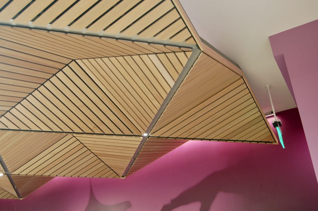 Specialty materials, such as linear wood ceilings, can be cut into custom shapes