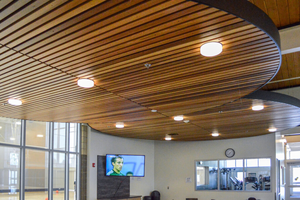 Custom Stain panelized linear wood ceiling by 9Wood at Rainer Beach Community Center in Seattle, WA