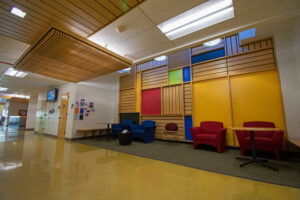 http://9Wood's%201400%20Dowel%20Cross%20Piece%20Grille%20in%20White%20Maple%20Veneer%20with%20coordinating%20Veneer%20Trim%20in%20an%20education%20setting.