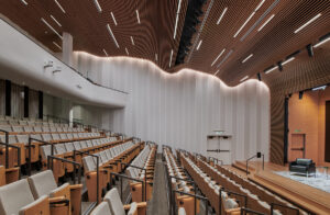 http://9Wood's%208100%20Wave%20Grille%20in%20White%20Oak%20Veneer%20with%20a%20Custom%20Stain%20in%20a%20University%20Auditorium.