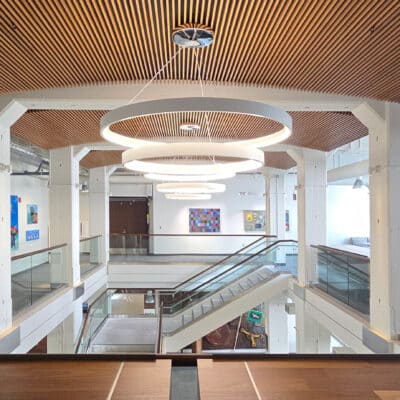 9Wood's 1100 Cross Piece Grille in Walnut Veneer in a university setting.
